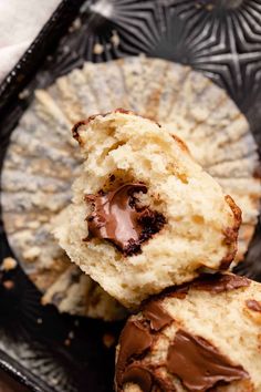 two chocolate covered biscuits on a black plate