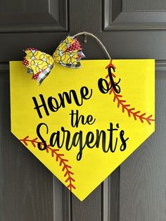 a yellow sign that says home of the sargonts hanging on a door