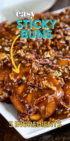 sticky buns with caramel drizzle and pecans in the middle on a white plate