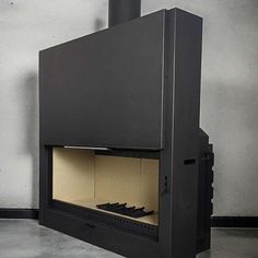 a black stove sitting in the middle of a room