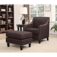 a living room with a chair, ottoman and bookcase in front of a window