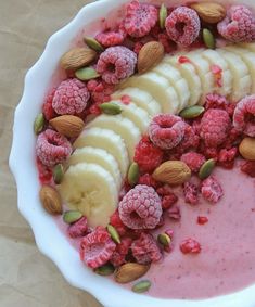 a white bowl filled with fruit and nuts