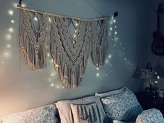 a bed with pillows and string lights hanging from the headboard