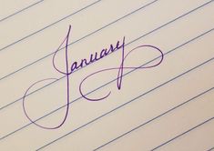 the word january written in cursive writing on lined paper