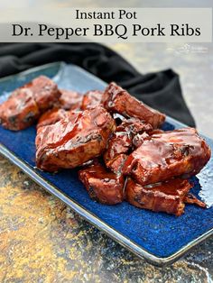 a blue plate topped with meat covered in bbq pork ribs