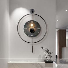 a clock mounted to the side of a wall next to a marble counter top in a room