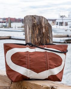 a brown and white bag sitting on top of a wooden post