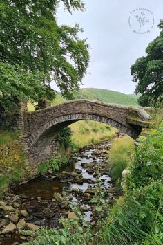 an old stone bridge over a small stream