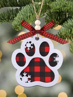 a dog paw ornament hanging from a christmas tree