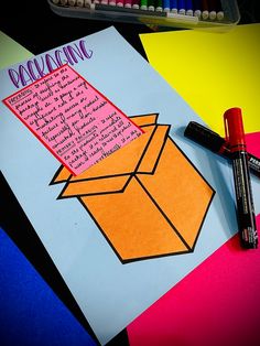 an open box with writing on it next to crayon markers and colored pencils