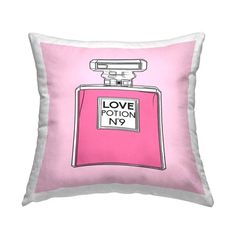 a pink and white pillow with a bottle of perfume on the front that says love potion no 9