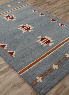 a blue rug with red and white designs on it