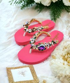 Description The beautiful rhinestone and customizable Flip Flops are for beach brides, bridesmaids, vacations, honeymoons, or any occasion you desire to look gorgeous. Perfect in any outfit! Being unique and stunning in design, these flip flops must be your must-have item! The sandal is anti-slip, comfortable, and durable as it is made from high-quality rubber from the South of Thailand, which is famous for the best rubber tree. Moreover, the crystals are decorated on the sandal with effective adhesive glue and knitting threads by hand stitching. Don't worry when you walk on the beach or use it in the rainy season. For anyone who loves a real handmade product, don't miss out! Product Description: - Thailand High-Quality Rubber Sole - Luxury Crystals/Rhinestones  - High-quality PU gold thre Glamorous Adjustable Embellished Sandals, Pink Sandals For Beach Party, Pink Sandals For Beach Season Parties, Embellished Sandals For Beach Party, Embellished Sandals For Beach Season Parties, Embellished Flip Flops For Summer Party, Bedazzled Sandals For Summer Beach, Open Toe Embellished Flip Flops For Party, Summer Bedazzled Sandals For Beach