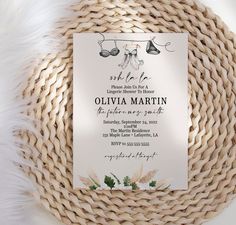 a white wedding card on top of a wicker basket