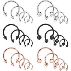 six different types of metal nose rings with arrows and balls on each side, all in various