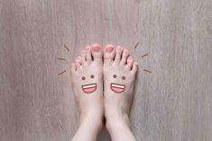 someone has their feet painted with smiley faces