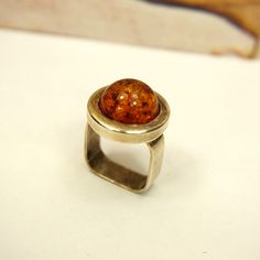 "UNUSUAL AMBER RING Size 8 with Stamped 925 silver square shank, Round honey amber, Rare to find jewelry, Unisex ring gift, Mothers Day Gift. Modernist amber ring. Polish jewelry. Artisan made. Amber jewelry gift. Fathers Day Gift. GENUINE BALTIC AMBER and 925 STERLING SILVER. AMBER RING SIZE 8. STAMPED 925 MORE UNIQUE RINGS: https://www.etsy.com/shop/ANTIQUE4YOU?ref=seller-platform-mcnav§ion_id=16313290 *BEFORE PLACING ORDER, PLEASE, MAKE SURE YOUR ADDRESS IS CORRECT IF YOU PLACED ORDER WITH UNVERIFIED ADDRESS OR HAD MISTAKE IN IT AND IF PACKAGE RETURNED FOR THIS REASON SHIPPING FEES WILL BE DEDUCTED FROM YOUR REFUND **Before you return an item, please contact me first. I accept returns only if the item you received is not as described and doesn't look as pictured. Any other reason-as \"I Modern Brown Rings For Gift, Modern Brown Rings For Gifts, Handmade Modern Amber Rings, Modern Handmade Amber Rings, Modern Orange Rings For Gift, Modern Orange Rings For Gifts, Modern Orange Rings As Gifts, Square Rings With Polished Finish For Gifts, Amber Ring