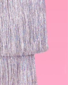 a woman's silver dress on a pink background