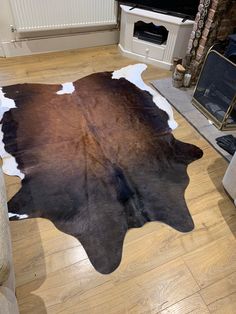 a living room with a cowhide rug on the floor