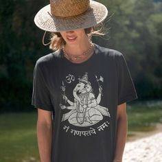 Thanks for Checking out this Hindu Deity Lord Ganesh Tshirt. Ganesha, The remover of obstacles, is a great energy to call on to help you move forward when you feel stuck. This shirt is a great casual staple for days out, or to yoga class when you want the inspiration of Ganesha to help you through tough yoga sequences. This T-shirt, the Gildan 5000 is the classic Casual fashion staple. It's a great fit with a durable long lasting fabric. It the same tee that has bee used for decades for Biker, w Graphic Print Yoga Top For Summer, Cotton Relaxed Fit Top For Meditation, Cotton Graphic Print Shirt For Festivals, Cotton Shirt With Graphic Print For Festivals, Graphic Print Cotton Shirt For Festivals, Festival T-shirt With Screen Print And Relaxed Fit, Relaxed Fit Graphic Print Tops For Meditation, Casual Tops With Graphic Print For Festivals, Crew Neck Cotton Shirt For Festivals