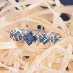 an image of a ring with blue stones on it