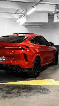 a red sports car parked in a parking garage