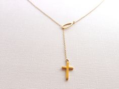 A beautifully detailed Lariat Cross Necklace, hand crafted in sterling silver. This pendant comes with a delicate silver link chain with our shops insignia; a charm of a key with the letter V at the clasp. This unique necklace will make the perfect gift for anyone. Material: Sterling Silver Pendant Size: about 1 inch Chain Length: 18 inch Silver Link Chain with 1 inch extension *All purchases will arrive in a gift box! *Available in silver, Rose gold plated and yellow gold plated versions. Other Classic Lariat Necklace Gift, Classic Lariat Necklace For Gifts, Classic Gift Lariat Necklace With Delicate Chain, Spiritual Sterling Silver Lariat Necklace Gift, Classic Lariat Necklace With Delicate Chain For Gift, Sterling Silver Teardrop Lariat Necklace As Gift, Classic Sterling Silver Lariat Necklace Gift, Lariat Necklace With Polished Finish As Gift, Polished Lariat Necklace For Gift