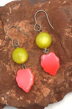 Add a bold pop of color to your wardrobe with our Yellow & Neon Orange Leaf Moonglow Statement Earrings! These eye-catching earrings feature neon orange leaf shapes, perfect for making a statement and adding a touch of playfulness to any outfit. Handcrafted with moonglow accents, they will add a unique and dazzling touch to any look. Don't miss out on this must-have accessory! Earring measures 2 1/8" in length & are super light weight. Earrings are made with mostly vintage lucite parts that were Vibrant Orange Dangle Jewelry, Vibrant Orange Drop Earrings, Bold Orange Party Jewelry, Bold Orange Drop Earrings, Yellow Neon, Orange Leaf, Moon Glow, Vintage Lucite, Light Weight Earrings