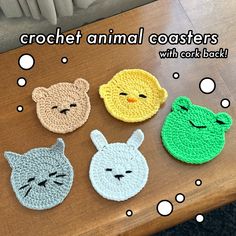 four crochet animal coasters sitting on top of a wooden table with bubbles