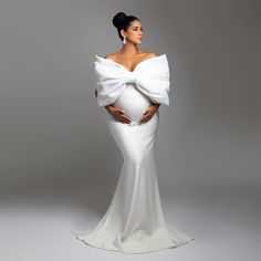 a pregnant woman in a white gown