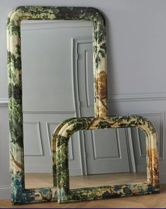 two mirrors sitting next to each other on top of a wooden floor