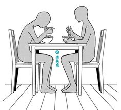 two people sitting at a table eating food