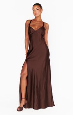 Raise a glass in the Anderson Maxi Dress! Sleek, chocolate satin shapes this chic dress with an open back and criss cross ties. This flattering, floor length dress exudes glamour. Style with strappy heels and dainty gold jewelry for your next event. Backless Brown Maxi Dress For Party, Brown Backless Maxi Dress For Party, Elegant Brown Slip Dress With Spaghetti Straps, Elegant Evening Slip Dress With Strappy Back, Gold Satin Maxi Dress For Date Night, Elegant Brown Backless Maxi Dress, Brown Silk Maxi Dress For Party, Chic Satin Maxi Dress With Strappy Back, Elegant Satin Dress With Strappy Back For Night Out