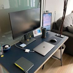 a desk with a laptop, monitor and keyboard on it