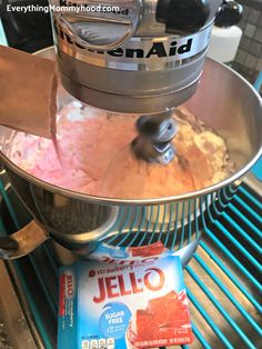 a stand mixer with jello in it on top of a counter next to a packet of jello