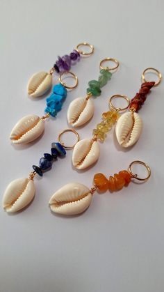 Set of 7 loc rings made with chakra gemstones, Amethyst, Lapis Lazuli, Sodalite, Aventurine, Citrine, Orange Aventurine, dyed Agate, with cowrie shell on brass rings.  Rings fit all braids and locs. Locs Jewelry Hairstyles, Bohemian Spiral Jewelry For Healing, Bohemian Spiral Jewelry For The Beach, Spiritual Gemstone Jewelry For Beach, Unique Gemstone Jewelry For The Beach, Bohemian Spiral Hand Wrapped Jewelry, Bohemian Beach Jewelry With Gemstones, Hair Jewelry Locs, Bohemian Amber Jewelry For Beach