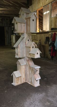 a wooden birdhouse is stacked on top of each other