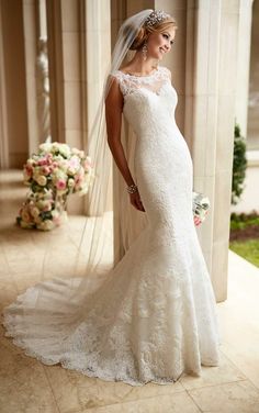 a woman in a wedding dress posing for the camera