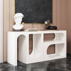 a white console table in front of a black and gold painting