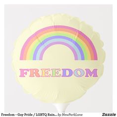 a white balloon with a rainbow and the word freedom written in pink on it