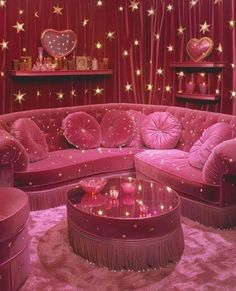 a living room with pink furniture and stars on the walls