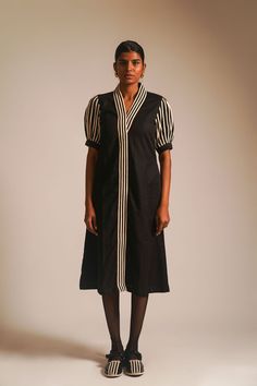 Indulge in understated glamour with our black long A-line dress in cotton fabric, a perfect union of grace and style. The overlapped neckline, adorned with intricate dori details, creates an alluring focal point. The front placket and half-puffed sleeves feature additional dori embellishments, adding a touch of sophistication. Side pockets provide a practical element, while the front hook opening adds a hint of modernity to this timeless ensemble, making it an ideal choice for any elegant affair.The model is 5'9'' and wearing S.Material: 100% CottonCare: Dryclean Only Half Sleeve Dress, Understated Glamour, Dresses Xxl, Half Sleeve Dresses, Puffed Sleeves, Half Sleeve, Long A Line, Dresses Xs, Half Sleeves