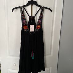 Nwt! Free People Bohemian Style Black Dress With Colorful Floral Embroider On Top And Tie Tassels. Never Been Worn! Black Bohemian V-neck Sundress, Black Bohemian Sleeveless Sundress, Black Mini Dress With V-neck For Festival, Black Bohemian Mini Dress For Summer, Black V-neck Mini Dress For Festival, Black Sundress For Festival, Black Sleeveless Bohemian Mini Dress, Black Bohemian Dress With Spaghetti Straps, Bohemian Black Sundress For Summer