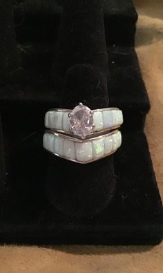 an opal and diamond ring sits on a velvet display case in a jewelry store