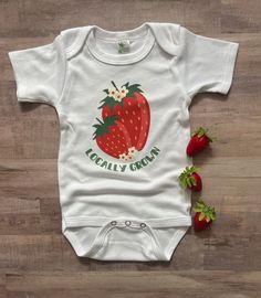 Do you have a 'locally grown' little one- or know someone who does? This strawberry bodysuit makes a great gift, baby announcement or just a cute everyday outfit! Image is a DTF transfer and will last through all the washes! Comfy enough for your little one to play in all day!  All shirts are made to order and my current turn around time is about 2 weeks until your order will ship. Please keep this in mind when ordering. Cute Strawberry Print T-shirt As Gift, Strawberry Onesie, Baby Strawberry Dress, Cute Strawberry Print T-shirt For Spring, Strawberry Romper, Strawberry Baby, Sewing Business, Locally Grown, Cute Fruit