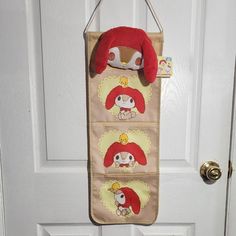 a door hanger hanging on the side of a white door with an animal design