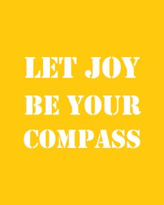 the words let joy be your compass written in white letters on a bright yellow background