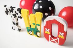 the letters are made out of wood and decorated with farm animals, barnyards, and balloons