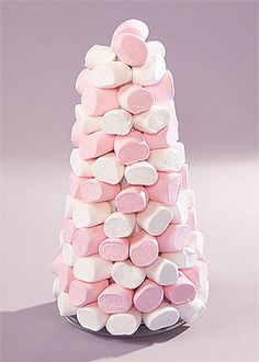 there is a pink and white candy tree made out of marshmallows on the table