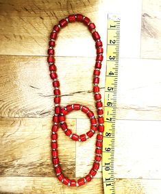 Yoruba royal red or coral color beads set reinforced with "invisible" clear beads. The children's set includes Red color. This set includes neckwear and one wristband bracelet. The neck bead is about 11 inches long. The beads are reinforced with "invisible" clear beads. It is suitable for both males and females. The adult set includes Coral color. Neckwear and two wristband bracelets.  The neck bead is about 15 inches long. Beads are reinforced with "invisible" clear beads and gold-plated sheets Red Adjustable Beaded Necklaces With Spacer Beads, Adjustable Red Beaded Bracelets With Wooden Beads, Adjustable Red Beads With Large Beads, Adjustable Red Large Beads, Nigerian Royalty, Yoruba People, Bead Diy, Clear Beads, Doll Jewelry